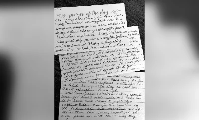 Handwritten letter pages on a table